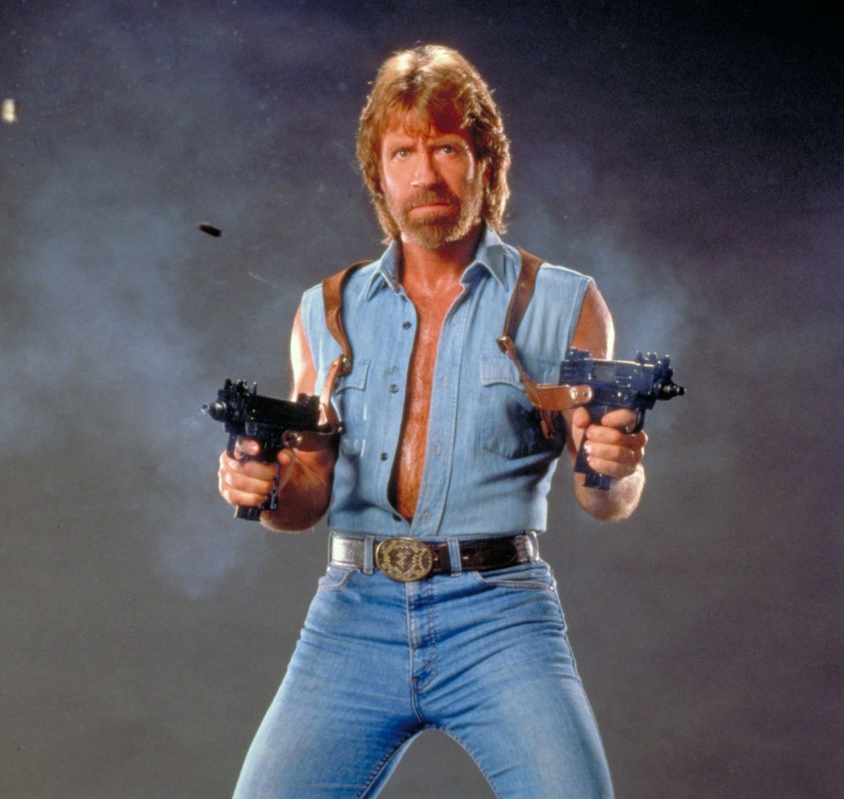 Chuck Norris holding guns profile photo